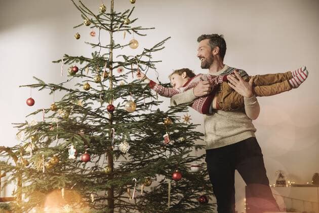 Father and son decorating Christmas tree model released Symbolfoto property released  MFF002796