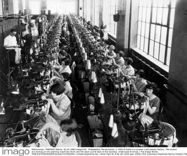 Philadelphia, Pennsylvania: c. 1922 A scene in a women s silk hosiery factory. The women are working on the seaming machines which sew the seam up the back of the stocking. Underwood Archives The Image Works xUnderwoodxArchives 1-Work-Fact-W_8