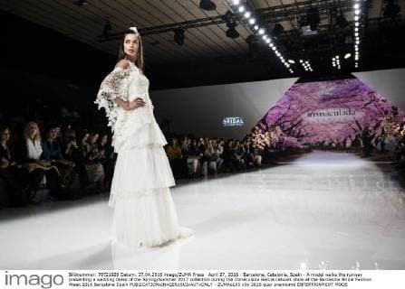 April 27, 2016 - Barcelona, Catalonia, Spain - A model walks the runway presenting a wedding dress of the Spring Summer 2017 collection during the Inmaculada Garcia catwalk show at the Barcelona Bridal Fashion Week 2016 Barcelona Spain - ZUMAo105