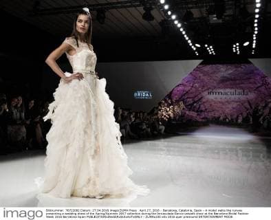 April 27, 2016 - Barcelona, Catalonia, Spain - A model walks the runway presenting a wedding dress of the Spring Summer 2017 collection during the Inmaculada Garcia catwalk show at the Barcelona Bridal Fashion Week 2016 Barcelona Spain - ZUMAo105