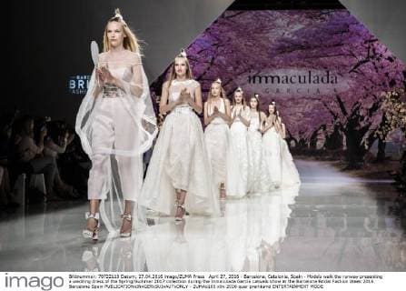 April 27, 2016 - Barcelona, Catalonia, Spain - Models walk the runway presenting a wedding dress of the Spring Summer 2017 collection during the Inmaculada Garcia catwalk show at the Barcelona Bridal Fashion Week 2016 Barcelona Spain - ZUMAo105
