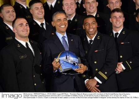 President Barack Obama poses with members of the United States Naval Academy Football Team after presenting them with the 2015 Commander-in-Chief?s Trophy, at the White House in Washington, D.C. on April 27, 2016. The Commander-in-Chief s Trophy is awarded to each season s winner of the American college football triangular series among the teams of the U.S. Military Academy, the U.S. Naval Academy, and U.S. Air Force Academy.  WAP20160427332 KEVINxDIETSCH