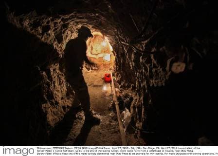 April 27, 2016 - CA, USA - San Diego, CA. April 27, 2016 Lance LeNoir of the Border Patrol s Tunnel Rat team, walks to the end of the Galvez tunnel, which came north from a warehouse in Tijuana, near Otay Mesa. Border Patrol officials keep one of the many tunnels discovered near Otay Mesa as an example for new agents, for media purposes and training operations. Known as the Galvez tunnel, it s an example of one of the more developed tunnels, having nearly twice the height of the recently discovered tunnels, with electrical wiring and rails for moving bundles under the border. Mandatory photo credit: USA - ZUMAs44_