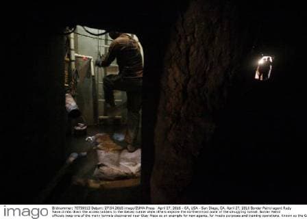 April 27, 2016 - CA, USA - San Diego, CA. April 27, 2016 Border Patrol agent Rudy Nava climbs down the access ladders to the Galvez tunnel while others explore the northernmost point of the smuggling tunnel. Border Patrol officials keep one of the many tunnels discovered near Otay Mesa as an example for new agents, for media purposes and training operations. Known as the Galvez tunnel, it s an example of one of the more developed tunnels, having nearly twice the height of the recently discovered tunnels, with electrical wiring and rails for moving bundles under the border. Mandatory photo credit: USA - ZUMAs44_
