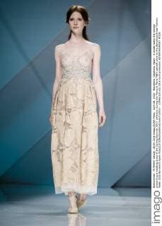 April 28, 2016 - Barcelona, Catalonia, Spain - A model walks the runway presenting a wedding dress of the Spring Summer 2017 collection during the Marco & Maria M&M catwalk show at the Barcelona Bridal Fashion Week 2016 Barcelona Spain - ZUMAo105