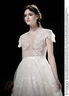 April 28, 2016 - Barcelona, Catalonia, Spain - A model walks the runway presenting a wedding dress of the Spring Summer 2017 collection during the Marco & Maria M&M catwalk show at the Barcelona Bridal Fashion Week 2016 Barcelona Spain - ZUMAo105