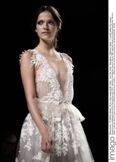 April 28, 2016 - Barcelona, Catalonia, Spain - A model walks the runway presenting a wedding dress of the Spring Summer 2017 collection during the Marco & Maria M&M catwalk show at the Barcelona Bridal Fashion Week 2016 Barcelona Spain - ZUMAo105