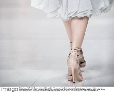 April 28, 2016 - Barcelona, Catalonia, Spain - A model walks the runway presenting a wedding dress of the Spring Summer 2017 collection during the Marco & Maria M&M catwalk show at the Barcelona Bridal Fashion Week 2016 Barcelona Spain - ZUMAo105