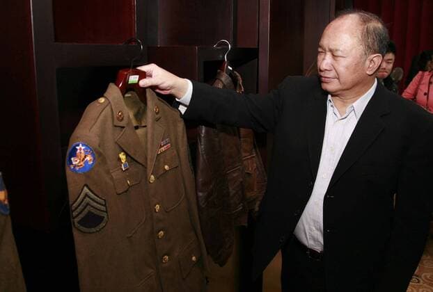 Mar 06, 2011 - Kunming, Yunnan, China - Hong Kong director JOHN WOO checks a uniform of the American Volunteer Group (AVG) for his new film Flying Tiger Heroes at the museum in Kunming in southwest China s Yunnan province on Sunday, March 6, 2011. John Woo s new film Flying Tiger Heroes will have a budget of over $90 million. The film will be about The Flying Tigers, known otherwise as The 1st American Volunteer Group (AVG), a fighter squadron that flew missions to aid China against the Japanese in World War II.  - ZUMAc32_