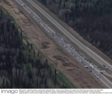 Aerial view of highway 63, south of Fort McMurray, taken from a CH-146 Griffon helicopter on May 5, 2016. The Canadian Armed Forces have air assets deployed in support of the Province of Alberta s wildfire emergency response efforts. At the time this image was taken, a mandatory evacuation had been placed on all of Fort McMurray - the largest evacuation on record in Canada. The fire had burned through nearly 77 square kilometers, razing neighborhoods across the city.  WAX2016050627 MCplxVanPutten