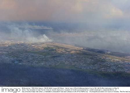 Aerial view of Fort McMurray taken from a CH-146 Griffon helicopter on May 5, 2016. The Canadian Armed Forces have air assets deployed in support of the Province of Alberta s wildfire emergency response efforts. At the time this image was taken, a mandatory evacuation had been placed on all of Fort McMurray - the largest evacuation on record in Canada. The fire had burned through nearly 77 square kilometers, razing neighborhoods across the city.  WAX2016050630 MCplxVanPutten