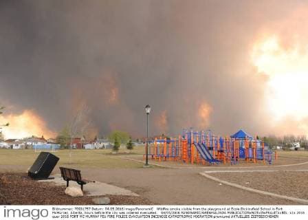 Wildfire smoke visible from the playground at Ecole Dickinsfield School in Fort McMurray, Alberta, hours before the city was ordered evacuated. 04 05 2016 PANORAMIC GREGHALINDA 