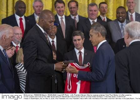 U.S. President Barack Obama receives a jersey from Thurl Bailey (L) after greeting former players and staff of the 1983 NCAA National Basketball Championship North Carolina State Wolfpack in the East Room of the White House in Washington, DC on May 9, 2016. The President and Vice President met briefly with members of the team and their families in the East Room. The team was previously unable to visit the White House to be recognized for their championship. Pool  WAX2016050910111 SHAWNxTHEW