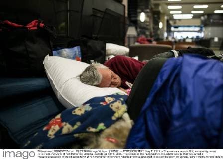 (160509) -- FORT MCMURRAY, May 9, 2016 -- Evacuees are seen in Bold community center in Lac la Biche south of Fort McMurray, Alberta, Canada on May 9, 2016. The spread of the huge wildfire in western Canada that has forced a massive evacuation in the oil sands town of Fort McMurray in northern Alberta province appeared to be slowing down on Sunday, partly thanks to favorable weather. ) CANADA-FORT MCMURRAY-WILDFIRE-AFTERMATH AmruxSalahuddien 