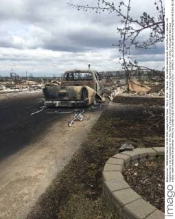 May 9, 2016 - Canada - Na-wildfire-demolition9..Fort McMurray s Beacon Hill neighbourhood was devastated by the fire. Here, a truck s tires have melted away and a hardened stream of silver, likely part of the truck s body, have melted on the driveway. Photo by Canada  - ZUMAt14_