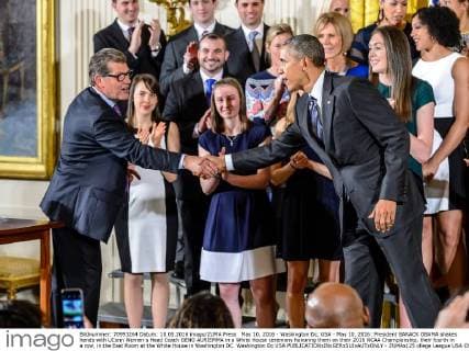 May 10, 2016 - Washington Dc, USA - May 10, 2016: President BARACK OBAMA shakes hands with UConn Women s Head Coach GENO AURIEMMA in a White House ceremony honoring them on their 2016 NCAA Championship, their fourth in a row, in the East Room at the White House in Washington DC. Washington Dc USA - ZUMAs125