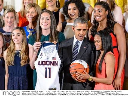 May 10, 2016 - Washington, District of Columbia, U.S. - President BARACK OBAMA gets souvenirs from UConn Women s basketball team during the White House ceremony honoring them on their 2016 NCAA Championship, their fourth in a row, in the East Room at the White House. Washington Dc USA - ZUMAs125