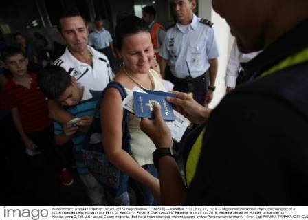 (160510) -- PANAMA CITY, May 10, 2016 -- Migrantion personnel check the passport of a Cuban woman before boarding a flight to Mexico, in Panama City, capital of Panama, on May 10, 2016. Panama began on Monday to transfer to Mexico some 3,400 U.S.-bound Cuban migrants that have been stranded without papers on the Panamanian territory. ) (mv) (jg) PANAMA-PANAMA CITY-CUBAN MIGRANTS MauricioxValenzuela 