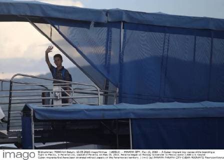 (160510) -- PANAMA CITY, May 10, 2016 -- A Cuban migrant boy waves while boarding a flight to Mexico, in Panama City, capital of Panama, on May 10, 2016. Panama began on Monday to transfer to Mexico some 3,400 U.S.-bound Cuban migrants that have been stranded without papers on the Panamanian territory. ) (mv) (jg) PANAMA-PANAMA CITY-CUBAN MIGRANTS MauricioxValenzuela 