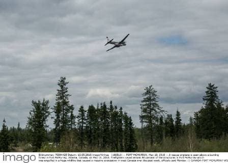 (160510) -- FORT MCMURRAY, May 10, 2016 -- A rescue airplane is seen above a burning forest in Fort McMurray, Alberta, Canada, on May 10, 2016. Firefighters saved almost 90 percent of the structures in Fort McMurray which was engulfed in a huge wildfire that caused a massive evacuation in west Canada over the past week, officials said Monday. () CANADA-FORT MCMURRAY-WILDFIRE-AFTERMATH AmruxSalahuddien 