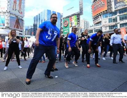 (160512) -- TORONTO, May 12, 2016 -- Participants wearing high-heel shoes warm up for the walk during the 7th annual Walk A Mile In Her Shoes event at Yonge-Dundas Square in Toronto, Canada, May 12, 2016. The event is expected to bring awareness to the role men can play in ending violence against women. ) CANADA-TORONTO-WALK A MILE IN HER SHOES ZouxZheng 