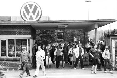 Unternehmen: Volkswagen Arbeiter verlassen durch ein Tor das VW Werk, Schichtwechsel, Feierabend, Belegschaft, Mitarbeiter, Volkswagen VW Produktion in Wolfsburg, SW-Aufnahme, 20.08.1981