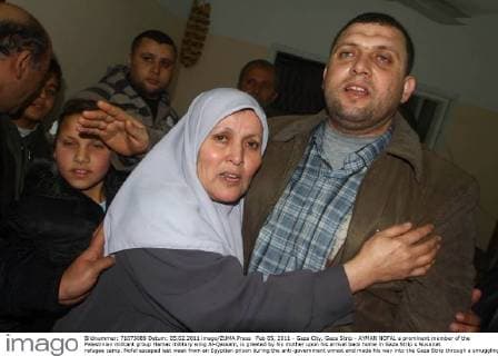 Feb 05, 2011 - Gaza City, Gaza Strip - AYMAN NOFAL a prominent member of the Palestinian militant group Hamas military wing Al-Qassam, is greeted by his mother upon his arrival back home in Gaza Strip s Nusairat refugee camp. Nofal escaped last week from an Egyptian prison during the anti-government unrest and made his way into the Gaza Strip through a smuggling tunnel under the border. He was greeted by a celebratory crowd, some of whom fired shots in the air. - ZUMAap3_