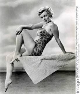 IMAGO ICONS: Marilyn Monroe American actress Marilyn Monroe posing sitting on the trampoline in a swimsuit 02738 