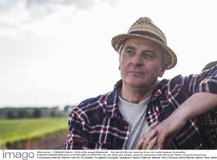 Portrait of a farmer wearing straw hat model released Symbolfoto  UUF007347