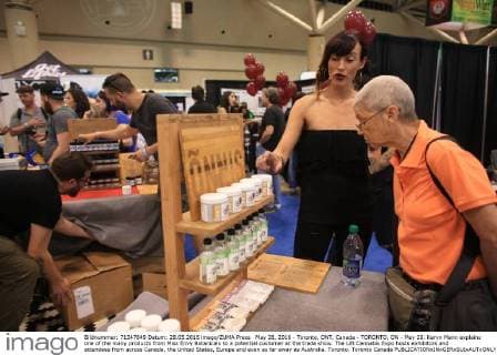 May 28, 2016 - Toronto, ONT, Canada - TORONTO, ON - May 28. Karyn Mann explains one of the many products from Miss Envy Botanicals to a potential customer at the trade show. The Lift Cannabis Expo hosts exhibitors and attendees from across Canada, the United States, Europe and even as far away as Australia. Toronto. Toronto Canada  - ZUMAt14_