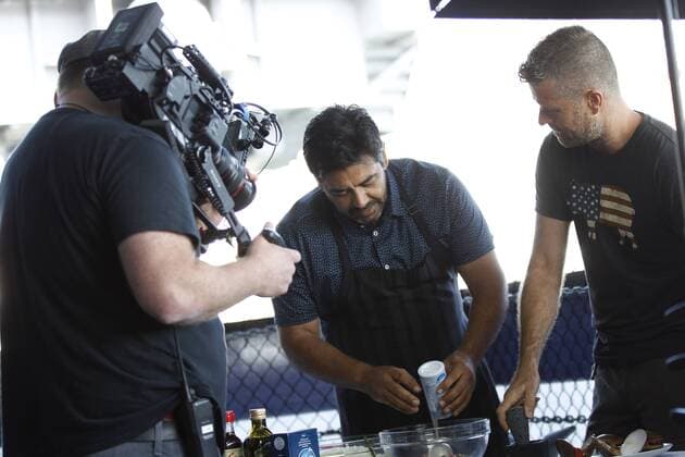 May 30, 2016 - San Diego, USA - SAN DIEGO, May 29, 2016 Local chef Javier Plascencia, center, cooks as host Pete Evans observes as a film crew tapes an episode of the PBS cooking show Moveable Feast with Fine Cooking while aboard the USS Midway Museum in San Diego on Monday. Photo by Hayne Palmour IV San Diego Union-Tribune Mandatory Credit: HAYNE PALMOUR IV SAN DIEGO UNION-TRIBUNE ZUMA PRESS San Diego Union-Tribune Photo by Hayne Palmour IV copyright 2016 San Diego USA - ZUMAs44_