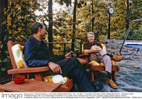 Jan. 18, 2011 - Thurmont, Maryland, United States of America - President Anwar al-Sadat of Egypt, left, and United States President Jimmy Carter have a discussion on the porch of Aspen Lodge at Camp David, the US presidential retreat near Thurmont, Maryland as part of the Egypt-Israel Summit in September, 1978.. - ZUMAs152