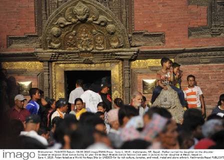 June 4, 2016 - Kathmandu, NP, Nepal - Father carried his daughter on the shoulder to observe religious ritual dance during 12 year Shree Bagh Bhairab Dance festival (not seen in picture) to her daughter at Patan, Nepal on June 4, 2016. Patan listed as a World Heritage Site by UNESCO for its rich culture, temples, and wood, metal and stone artwork. Kathmandu Nepal  - ZUMAn230