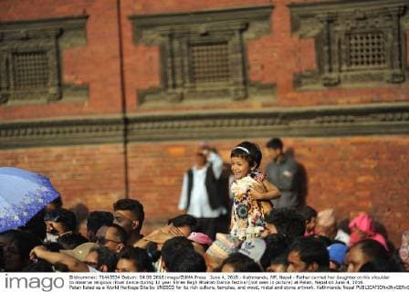 June 4, 2016 - Kathmandu, NP, Nepal - Father carried her daughter on his shoulder to observe religious ritual dance during 12 year Shree Bagh Bhairab Dance festival (not seen in picture) at Patan, Nepal on June 4, 2016. Patan listed as a World Heritage Site by UNESCO for its rich culture, temples, and wood, metal and stone artwork. Kathmandu Nepal  - ZUMAn230