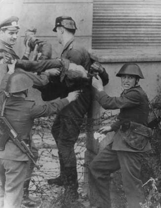 A shot in the back toppled young Peter Fechter just short of freedom, as he tried to flee over the Wall from East Berlin. - ZUMAg49_