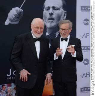 Composer and conductor John Williams (L) and director Steven Spielberg mingle on the red carpet as they arrive for American Film Institutes 44th Life Achievement Award gala tribute to Williams at the Dolby Theatre in the Hollywood section of Los Angeles on June 9, 2016. Over six decades in Hollywood, Williams has written some of the most memorable music in movie history. His 100-plus features have earned 50 Academy Award nominations (making him the most-nominated living person), winning five times. Williams also received 22 Grammys, seven BAFTAs, five Emmys, four Golden Globes, a Kennedy Center Honor and the National Medal of Arts. And then there are all those iconic themes, the ones everyone in the world knows.  LAP2016060906 JIMxRUYMEN