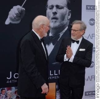 Composer and conductor John Williams (L) and director Steven Spielberg mingle on the red carpet as they arrive for American Film Institutes 44th Life Achievement Award gala tribute to Williams at the Dolby Theatre in the Hollywood section of Los Angeles on June 9, 2016. Over six decades in Hollywood, Williams has written some of the most memorable music in movie history. His 100-plus features have earned 50 Academy Award nominations (making him the most-nominated living person), winning five times. Williams also received 22 Grammys, seven BAFTAs, five Emmys, four Golden Globes, a Kennedy Center Honor and the National Medal of Arts. And then there are all those iconic themes, the ones everyone in the world knows.  LAP2016060907 JIMxRUYMEN