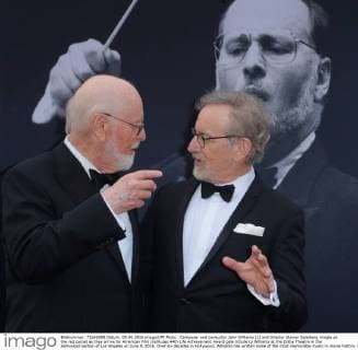 Composer and conductor John Williams (L) and director Steven Spielberg mingle on the red carpet as they arrive for American Film Institutes 44th Life Achievement Award gala tribute to Williams at the Dolby Theatre in the Hollywood section of Los Angeles on June 9, 2016. Over six decades in Hollywood, Williams has written some of the most memorable music in movie history. His 100-plus features have earned 50 Academy Award nominations (making him the most-nominated living person), winning five times. Williams also received 22 Grammys, seven BAFTAs, five Emmys, four Golden Globes, a Kennedy Center Honor and the National Medal of Arts. And then there are all those iconic themes, the ones everyone in the world knows.  LAP2016060909 JIMxRUYMEN