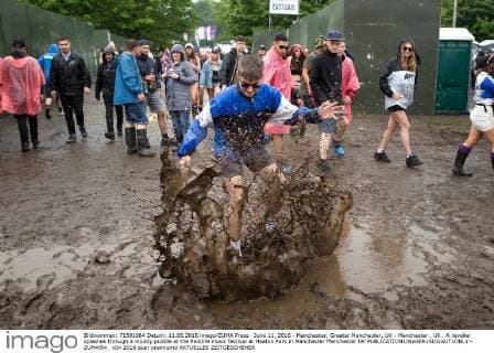 June 11, 2016 - Manchester, Greater Manchester, UK - Manchester , UK . A reveller splashes through a muddy puddle at the Parklife music festival at Heaton Park in Manchester Manchester UK  - ZUMAl94_