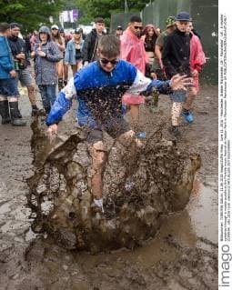 June 11, 2016 - Manchester, Greater Manchester, UK - Manchester , UK . A reveller splashes through a muddy puddle at the Parklife music festival at Heaton Park in Manchester Manchester UK  - ZUMAl94_