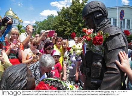 SIMFEROPOL, RUSSIA - JUNE 11, 2016: People attend the unveiling of a monument to Polite People honoring the servicemen who were in Crimea during preparations for the Crimean status referendum in 2014. Alexander Karpushkin TASS  TS026520