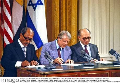 Dec. 31, 2010 - Washington, District of Columbia, United States of America - President Anwar Sadat of Egypt, left, United States President Jimmy Carter, center, and Prime Minister Menahem Begin of Israel, right, sign the Camp David Accords at signing ceremony for the in the East Room of the White House in Washington, D.C. on September 17, 1978.. - ZUMAs152