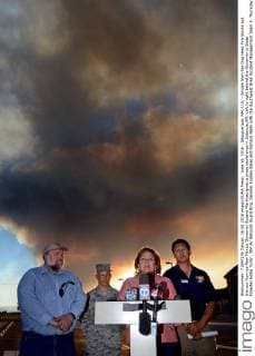 June 16, 2016 - Albuquerque, NM, U.S. - Smoke from the Dog Head Fire blocks out the sun from as New Mexico Governor Susana Martinez gives a press conference in Estancia,NM. Left to right behind the Governor is State Forester Eddie Tudor , NM Air National Guard Brig. General Andrew Salas and Richard Nieto with the Southwest Area Incident Management Team 5. Thursday June 16, 2016. Albuquerque U.S. - ZUMAab1_