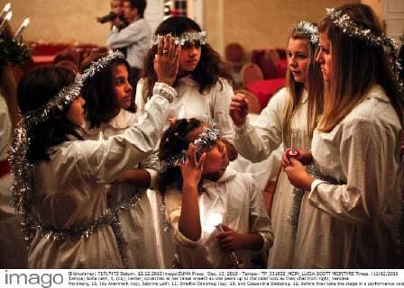 Dec. 12, 2010 - Tampa - TP_331632_MCIN_LUCIA.SCOTT MCINTYRE Times. (12 12 2010 Tampa) Sofia Leth, 5, (cq), center, scratches at her tinsel wreath as she peers up to the older kids as they chat from right, Vendela Nordberg, 15, Ida Akermark (cq), Sabrina Leth, 11, Emellie Odelskog (cq), 13, and Cassandra Odelskog, 12, before they take the stage in a performance celebrating St. Lucia (the saint of light), for the Swedish Club of Tampa Bay on Sunday evening. Young children and teenagers sang traditional Swedish songs along with American Christmas songs like, Rudolph, The Red Nose Reindeer, along with telling stories. St. Lucia is widely celebrated throughout Sweden on December 13. SCOTT MCINTYRE, Times - ZUMAs70_