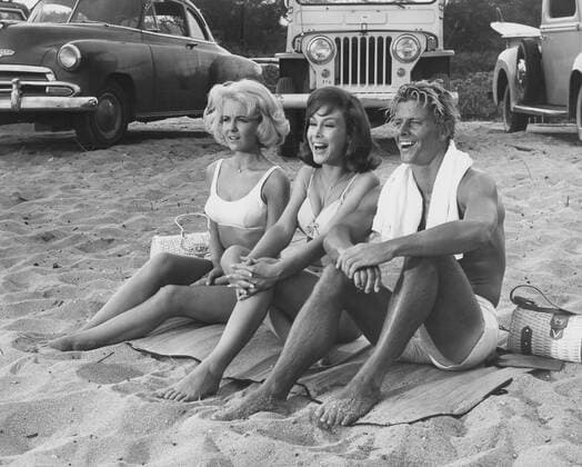 Dec. 14, 2010 - SHELLEY FABARES WTIH BARBARA EDEN AND PETER BROWN WATCH A SURFING CONTEST FROM WAIMEA BEACH IN A SCENE FROM COLUMBIA S RIDE THE WILD SURF 1964. - ZUMAg49_