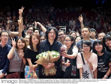 SHANGHAI, CHINA - JUNE 17: (CHINA OUT) Japanese director Shunji Iwai poses with fans after premiere of his new movie A Bride for Rip Van Winkle during the 19th Shanghai International Film Festival on June 17, 2016 in Shanghai, China.  CFP486653342