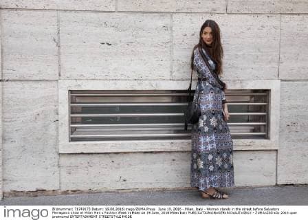 June 19, 2016 - Milan, Italy - Woman stands in the street before Salvatore Ferragamo show at Milan Men s Fashion Week in Milan on 19 June, 2016 Milan Italy  - ZUMAn230