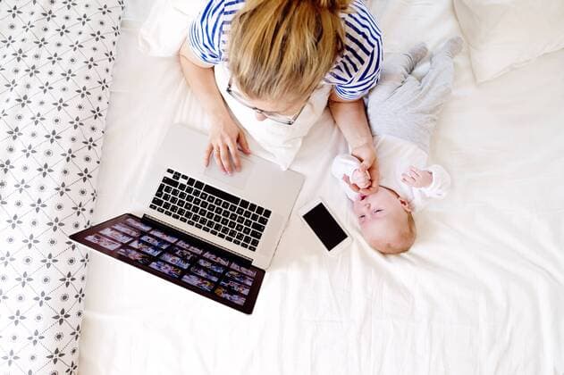 Mother with baby at home working with laptop model released Symbolfoto property released  HAPF000458