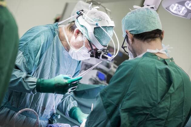 Heart surgeons and operating room nurse during a heart valve operation model released Symbolfoto property released  MWEF000061