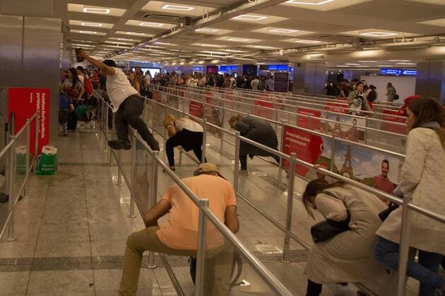 Travelers at the Ataturk Airport flee after two explosions followed by gunfire hit Turkey s biggest airport, killing dozens and injuring many on June 28, 2016, in Istanbul. All flights at Istanbul s Ataturk international airport were suspended, Turkish television stations reported.  TRK2016062901 LAURANCExCAMERON